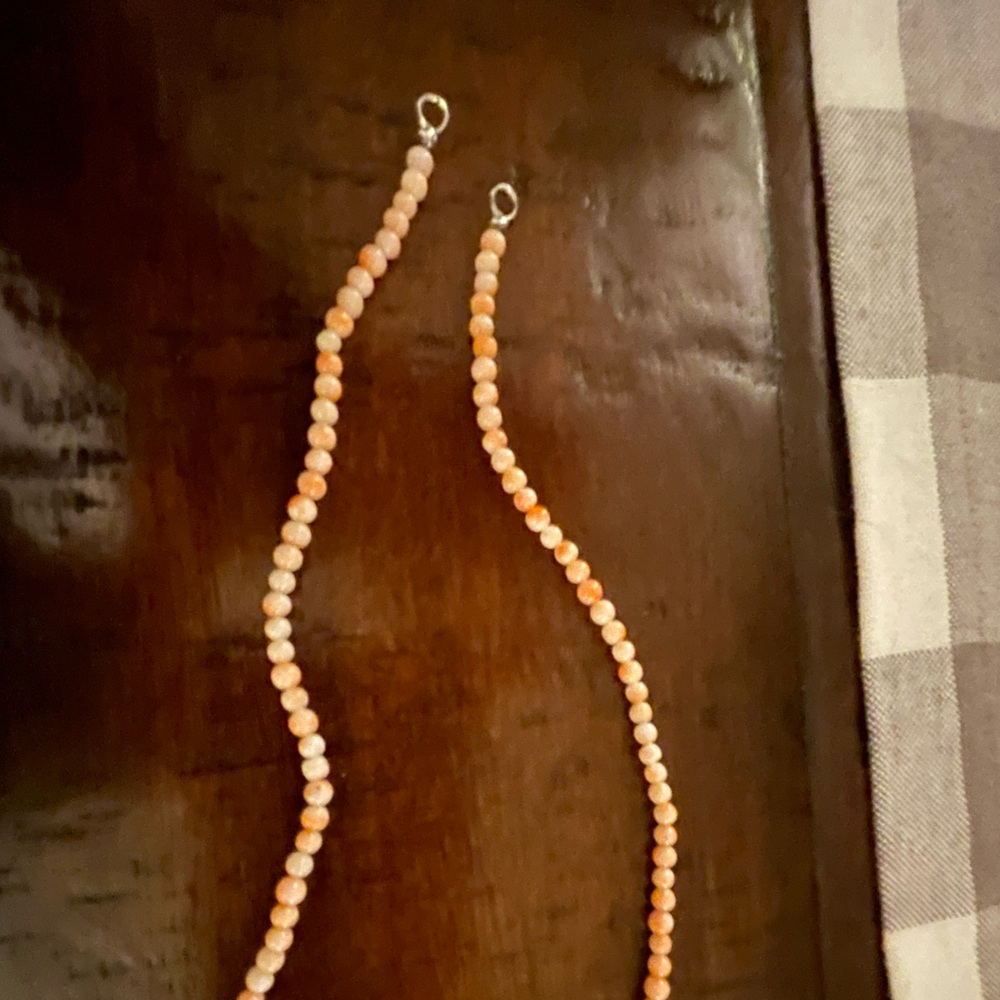 Coral bead strand. With silver open rings.